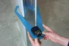 A person's hands are holding a blue measuring tool with a digital display against a wall. Produktbild-Vorschau
