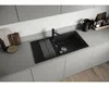 A modern kitchen sink with a black granite finish, featuring a faucet, drainer, and accessories on a light gray countertop. Podgląd zdjęcia produktu