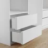 Close-up view of white drawers of a wardrobe on a wooden floor. Produktbild-Vorschau