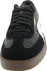 A close-up, front-facing view of a black Puma sneaker with white accents and a brown sole. Voir les images du produit