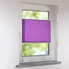 A purple pleated blind is installed in a white window frame, with a blurred green background visible through the window. Produktbild-Vorschau