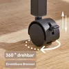 Close-up of a black caster wheel with a brake lever on a wooden floor. Produktbild-Vorschau