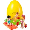 A yellow egg-shaped container with Playmobil figures on grass. Anteprima dell’immagine prodotto