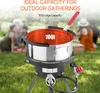 A propane fryer set for outdoor cooking is shown in a grassy area with people in the background. Anteprima dell’immagine prodotto