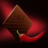 A piece of Lindt chocolate with chili and a chili pepper. Produktbild-Vorschau