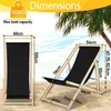 A diagram showing the dimensions of a black beach chair on a sandy beach with palm trees in the background. Anteprima dell’immagine prodotto