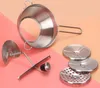 A stainless steel food mill with three interchangeable sieve inserts and a plunger mechanism is displayed on a pink and light orange background. Anteprima dell’immagine prodotto