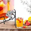 A beverage dispenser with a glass filled with fruit-infused water on a wooden table. Náhľad obrázku produktu