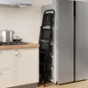 A black folding step stool is leaning against a silver refrigerator in a kitchen setting. Podgląd zdjęcia produktu
