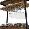 A wine rack with wine glasses hanging from it and wine bottles on the shelf below. Podgląd zdjęcia produktu
