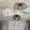 Three modern ceiling lights with intricate wireframe designs are mounted on a textured concrete ceiling. Náhled obrázku produktu