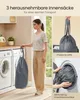 A woman is holding a laundry bag in a laundry room with washing machines. Produktbild-Vorschau