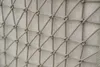 A close-up view of a woven rope pattern on a textured fabric background. Produktbild-Vorschau