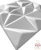 A close-up, angled view of a white, geometric 3D wall panel. Produktbild-Vorschau