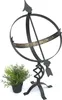 A sundial and a potted plant against a white background. Anteprima dell’immagine prodotto