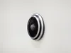 A close-up, side view of a digital peephole mounted on a light-colored wall. Produktbild-Vorschau