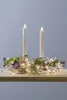 A decorative wreath with LED lights and two LED candles on a wooden surface. Produktbild-Vorschau