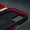 Close-up of the interior of a black phone case with red lining, showing a textured pattern and a small red accent. Anteprima dell’immagine prodotto
