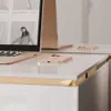 A close-up view of a desk with a laptop and a smartphone. Produktbild-Vorschau