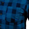 Close-up of a blue and dark blue checkered flannel shirt, showing a pocket and buttons. Podgląd zdjęcia produktu