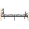 A metal bed frame with wooden posts on a white background. Produktbild-Vorschau