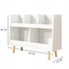 A white toy shelf with wooden legs, shown against a white background with dimensions indicated by lines and text. Náhľad obrázku produktu