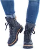 A pair of black lace-up boots worn with cuffed blue jeans, shown from the front. Anteprima dell’immagine prodotto