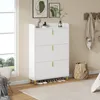 A white shoe cabinet with gold legs is shown in a room with a window and a rug. Produktbild-Vorschau