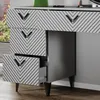A close-up view of a gray dresser with a geometric pattern on its drawers and black handles. Podgląd zdjęcia produktu