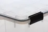 A close-up view of the corner of a transparent storage box with a black latch. Produktbild-Vorschau
