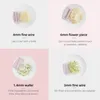A collage of four images, each showing a different attachment for a kitchen tool and the resulting cut vegetables. Produktbild-Vorschau