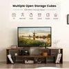 A TV stand with a television on it, and decorative items on the shelves. Produktbild-Vorschau