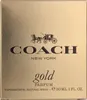 A close-up of a gold-colored perfume box. Voir les images du produit