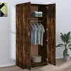 An open wardrobe with clothes hanging inside and folded on a shelf. Voir les images du produit