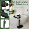A black C-shaped table with bath items on it, placed over a bathtub filled with water. Produktbild-Vorschau