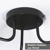 A close-up view of the ceiling mount and arms of a black chandelier. Produktbild-Vorschau