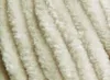 A close-up, textured view of cream-colored yarn. Náhľad obrázku produktu