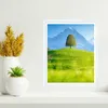 A framed picture of a landscape with a tree and mountains is displayed on a shelf next to decorative vases and a small plant. Anteprima dell’immagine prodotto