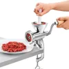A person is using a manual meat grinder to process meat, with a plate of ground meat in the foreground. Produktbild-Vorschau