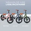 Three balance bikes in different colors are displayed side-by-side against a light gray background, with text above and below indicating color options. Produktbild-Vorschau