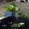 A solar-powered water pump with a small solar panel and a fountain spraying water into a pond with artificial lotus flowers. Náhled obrázku produktu
