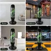Collage of four images showing an inflatable dinosaur punching bag in different settings: home, outdoors, office, and gym. Produktbild-Vorschau