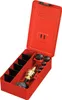 A red metal toolbox with various tools inside, including a brass tool with a black handle and several circular attachments. Produktbild-Vorschau