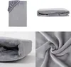 A collage of four images showing a gray fitted sheet from different angles, including a close-up of the fabric texture. Produktbild-Vorschau