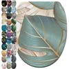 A collage of toilet seat designs, with a large central image of a toilet seat featuring a teal and gold leaf pattern. Náhled obrázku produktu