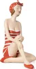 A decorative figurine of a woman in a retro swimsuit and swim cap, sitting with her legs crossed. Voir les images du produit