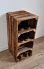 A rustic wooden shoe rack made of crates, standing against a white wall. Produktbild-Vorschau