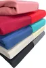A stack of folded blankets in various colors. Produktbild-Vorschau