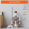 A vacuum cleaner and its charging/storage station are displayed against a plain wall. Produktbild-Vorschau