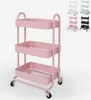 A pink three-tier rolling cart is shown against a white background. Several other carts in different colors are visible in the upper right corner of the image. Produktbild-Vorschau
